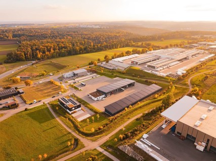 Industrial area on the edge of the forest, seen from above in autumn light, Nagold, Black Forest,