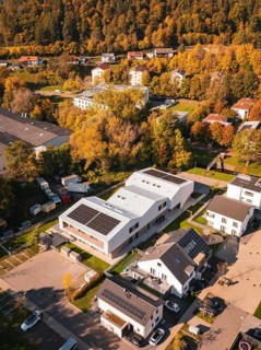 Residential area with modern buildings and solar panels, surrounded by autumnal nature, Nagold,