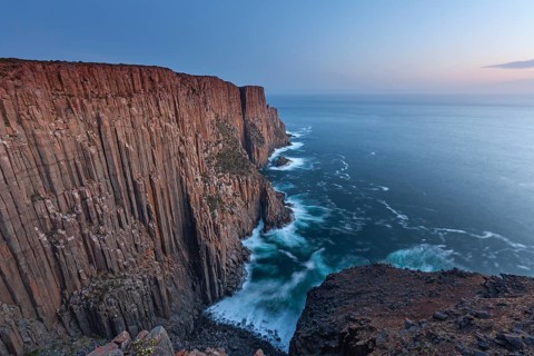 At The Gap, long exposure shows sunset over the cliffs of Cape Raoul. Golden light hits the sea and
