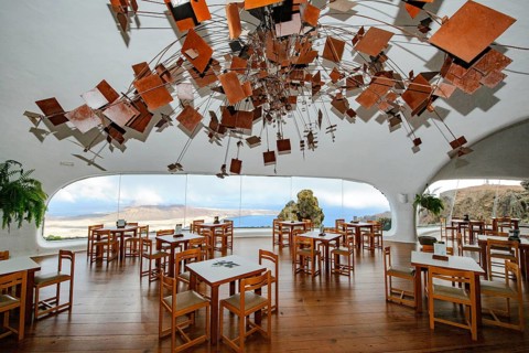 Interior of café with panoramic window in building designed by Cesar Manrique with the