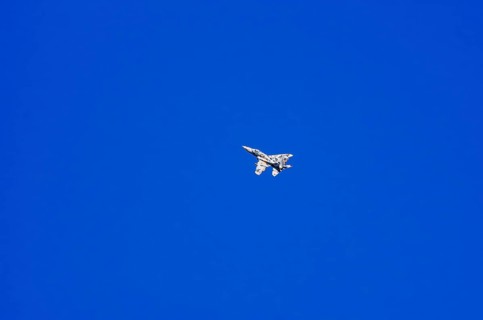 A single-jet fighter jet during a flight demonstration as part of an air show at the Rossfeld Air