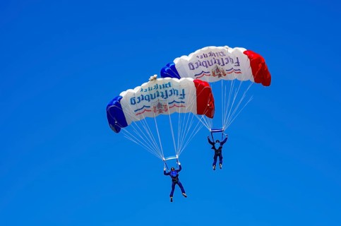 Skydivers during an aerial acrobatic performance as part of an air show at the Fliegerbergfest of