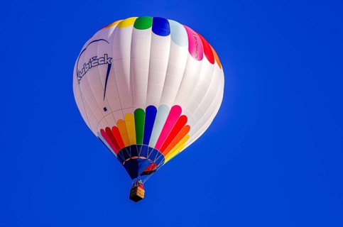 A hot air balloon, registration D-OÖJ, rises into the air as part of an air show at the