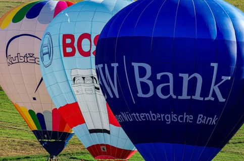 Hot air balloons are being prepared for takeoff as part of an air show at the Fliegerbergfest of
