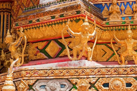 Gilded gold-colored statues figures of Buddhist temple guards mystical guards at Buddhist temple
