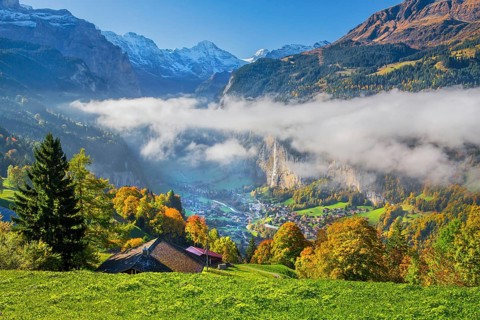 View from the village of the Lauterbrunnen Valley with Staubbach waterfall in autumn with morning