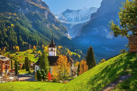 Village church in the town center with fieschörner 4049m in autumn, Grindelwald, Lütschinental,