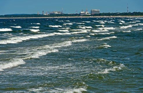 Baltic Sea waves, waves wash on the beach at the seaside resort of Ahlbeck, behind the skyline of
