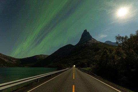 Magical Stetind mountain in northern Norway under auroras and full moon