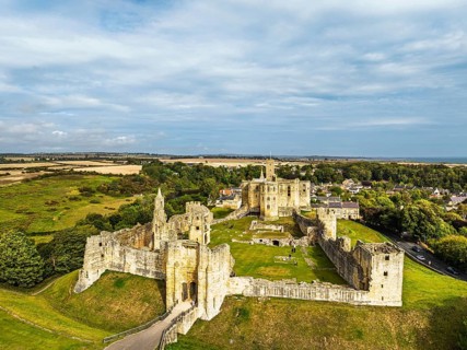Warkworth Castle over River Coquet from a drone, Warkworth, Northumberland, England, United Kingdom