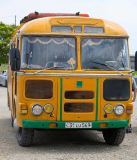 An old orange bus with retro design parked on a street, PAZ-672, minibus from Soviet manufacturer