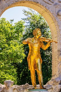 The gilded bronze statue of Johann Strauss, the Waltz King, memorial in the municipal park, Vienna,