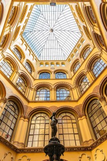 Donaunix fountain and glass dome in Palais Ferstel, Vienna, Austria