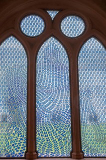 Colourful stained glass window with geometric patterns, the Pietà window by Thomas Bayrle, in the