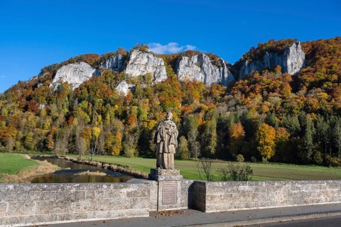 View from the historic arched bridge, Hausener Bridge across the Danube with the statue of Saint