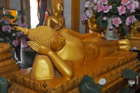 Reclining Buddha in golden color resting head on hand Unteram, Wat Chalong Monastery, Phuket