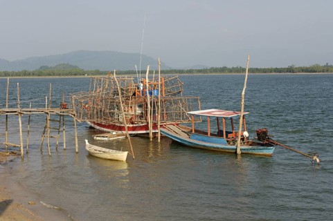 Small fishing boat on the right, boat on it lots of large bamboo traps, Phang Nga Phang-nga
