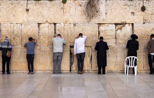 Orthodox and secular jews pray near Sacred Western Wailing Wall in Jerusalem Old City