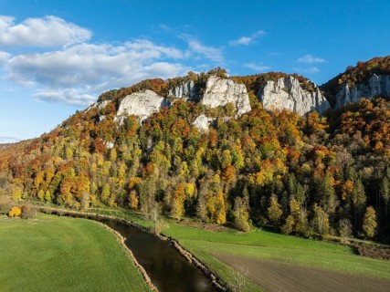 Aerial view of the Upper Danube Valley surrounded by autumn vegetation with the Hausender Peaks