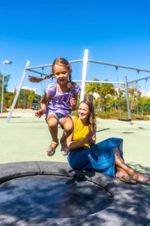 Mother and daughter experiencing a joyful moment together, with the young girl enthusiastically