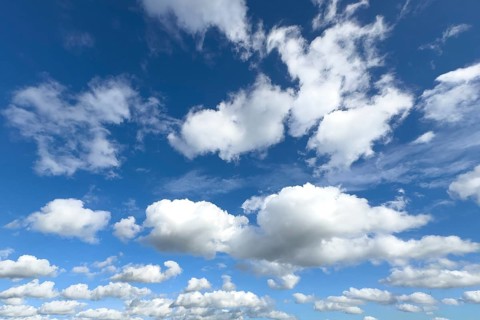 White clouds in the middle and below Cumulus above Stratocumulus loose cloudiness cloudy against