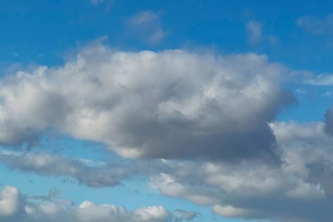 Large light gray Altocumulus Altocumulus cloud, behind more clouds under blue sky, international