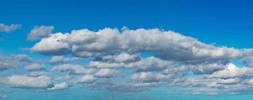 White clouds above Altocumulus in the background below Cumulus cloudy against blue cloudy sky,