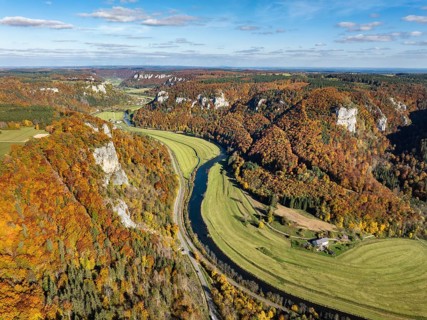 Aerial view of Upper Danube Valley surrounded by autumn vegetation, on the horizon Werenwag Castle,