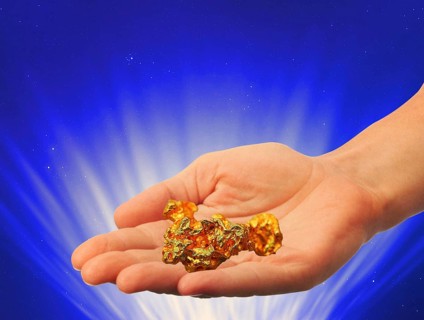 Symbolic photo, hand with gold nugget, stable value, risks, crash or upswing, financial economy,