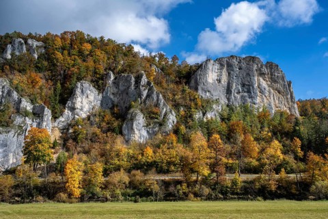 Distinctive Jurassic limestone cliffs in the upper Danube Valley, surrounded by autumn vegetation,