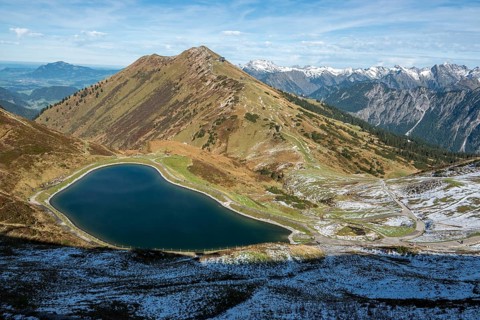 Reservoir, Kanzelwand snow-making pond, behind Fellhorn and mountains of the Allgäu Alps,