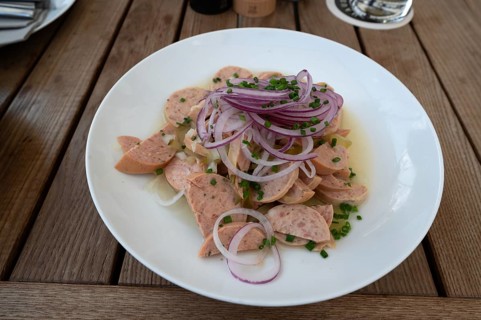 City sausage served with onions in a garden restaurant, Franconia, Bavaria, Germany