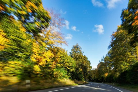 Car ride over winding country road, autumn leaves, sunny autumn weather, motion blur, Barntrup,