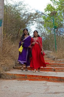 Young Indian woman on the red steps to Chamundi Hill, Mysore or Mysore, Karnataka, India