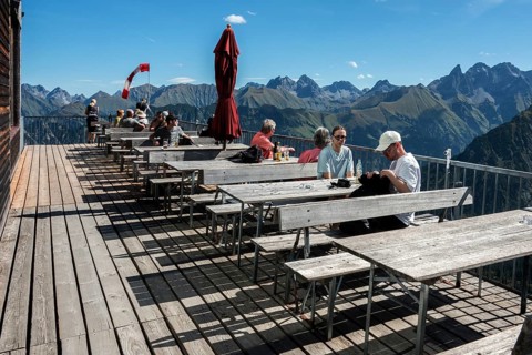 Terrace of the restaurant Gipfelstation Fellhornbahn, behind mountains of the Allgäu Alps,