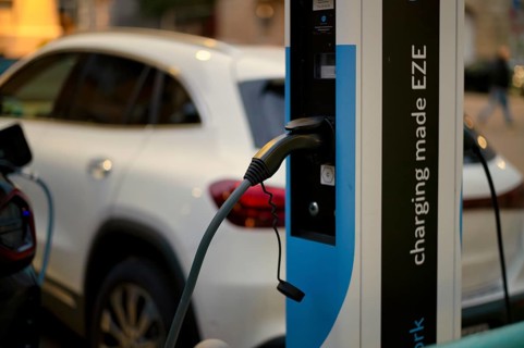 Parking lot with gas pump, EZE Network charging station, SICHARGE model for electric cars, charging