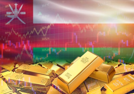 Gold bars on Oman flag in background. Gold bars stacked on Omani flag. Concept of Oman gold