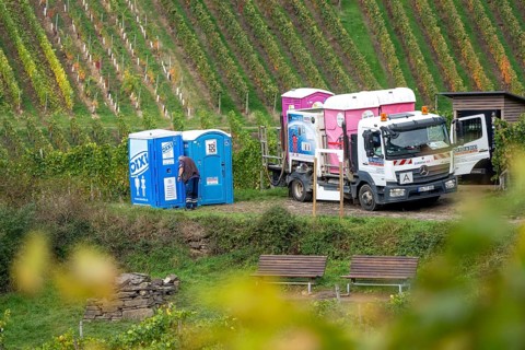 Emptying and cleaning mobile toilets Dixi toilets, Toi-Toi toilets in the vineyard in the Ahr
