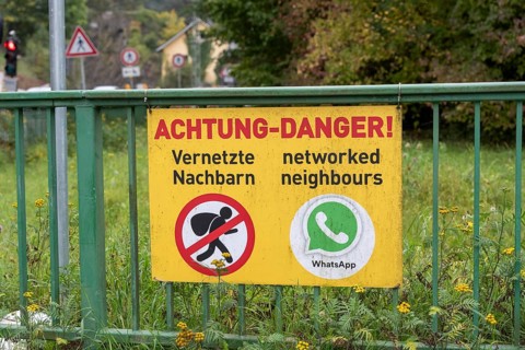Information sign on neighborhood protection, residents have connected via WhatsApp to warn each