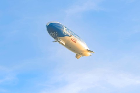 Zeppelin under a clear, cloudless sky, carrying an advertising message, Überlingen, Lake Constance,