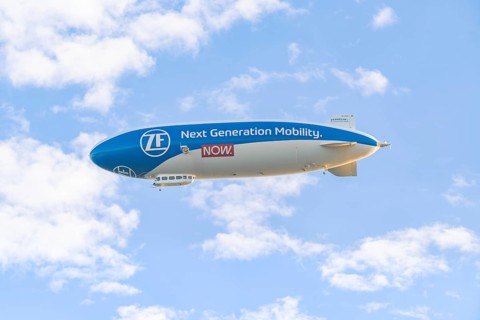 Zeppelin advertising new mobility in a blue sky with clouds, Überlingen, Lake Constance, Germany