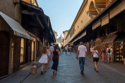 Ponte Vecchio, jewelry stores, dome of Santa Maria del Fiore Cathedral in the background, Florence,