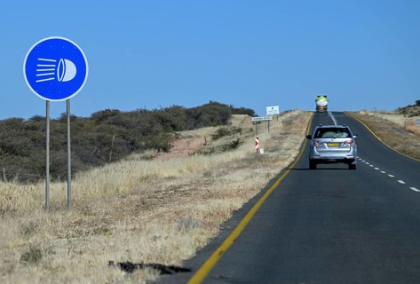 Light requirement sign for overland journeys on the B1 highway between Windhoek and Otjiwarongo,