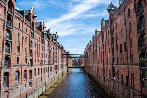 Canal between red brick buildings, warehouses in Hamburg's Speicherstadt, Hamburg, Germany