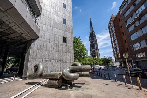 Deutsche Federal Bank building with modern sculpture, tower of the destroyed St. Nikolai church in