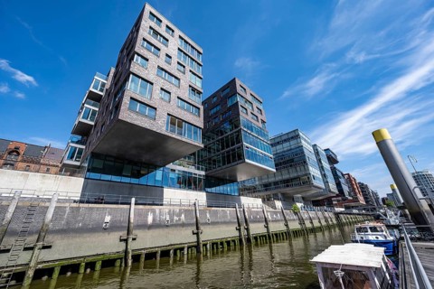 Modern residential buildings, traditional shipping harbor on Sandtorkai, behind Elbphilharmonie,