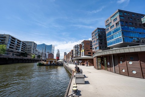 Modern residential buildings, pier at the traditional ship harbor on Sandtorkai, behind