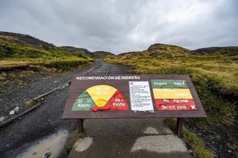 Warning sign for strong winds, gusts of wind on a hiking trail, Torres del Paine, Chile