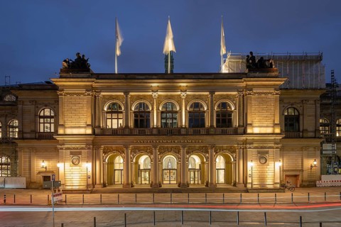 Building of the Hamburg Chamber of Commerce at blue hour with a strip of light in the foreground,