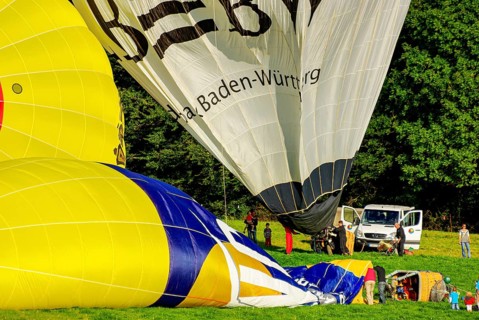 Hot air balloons being prepared for take-off as part of an air show at the Rossfeld in